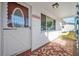 Front entrance with a white door and red tile porch at 5619 Marble Dr, New Port Richey, FL 34652