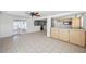 Bright kitchen with light wood cabinets, tile floor, and stainless steel sink at 5619 Marble Dr, New Port Richey, FL 34652