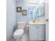 Clean bathroom with single vanity, toilet and mirrored medicine cabinet at 6145 Sun Blvd # 607, St Petersburg, FL 33715