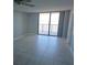 Inviting living room has neutral walls, tiled floor, and sliding glass doors to balcony with water views at 6145 Sun Blvd # 607, St Petersburg, FL 33715
