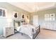 Main bedroom with large bed, dresser, and neutral color scheme at 6356 Camino Dr, Apollo Beach, FL 33572