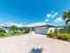 Single-story home with metal roof and paver driveway, nicely landscaped at 6510 Seabird Way, Apollo Beach, FL 33572