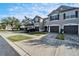 Three townhouses with gray exteriors and garages at 6912 Rock Springs Way, Tampa, FL 33625