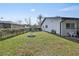 Spacious backyard featuring a fire pit and grassy area at 8209 Rugby Ct, Hudson, FL 34667