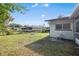 Large backyard with fire pit and partially covered patio at 8209 Rugby Ct, Hudson, FL 34667