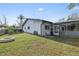 Backyard view showing patio, fire pit, and screened enclosure at 8209 Rugby Ct, Hudson, FL 34667