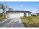 Updated single story home with a two car garage and landscaped lawn at 8209 Rugby Ct, Hudson, FL 34667