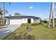 Updated single story home with a two car garage and landscaped lawn at 8209 Rugby Ct, Hudson, FL 34667
