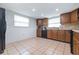 L-shaped kitchen with wood cabinets and black appliances at 8209 Rugby Ct, Hudson, FL 34667