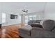 Living room with hardwood floors, sliding glass doors, and sectional sofa at 8209 Rugby Ct, Hudson, FL 34667