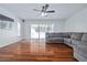 Living room with hardwood floors, sliding glass doors, and sectional sofa at 8209 Rugby Ct, Hudson, FL 34667
