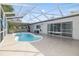 Inviting kidney-shaped pool with screened enclosure at 8209 Rugby Ct, Hudson, FL 34667