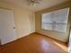 Bright bedroom with wood floors and large window at 822 Gulf Blvd # 4-6, Indian Rocks Beach, FL 33785