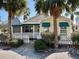 Beach cottage with teal awnings and white fence at 822 Gulf Blvd # 4-6, Indian Rocks Beach, FL 33785