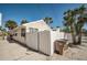 Rear of the house with a white fence and trash cans at 822 Gulf Blvd # 4-6, Indian Rocks Beach, FL 33785