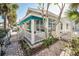 Charming cottage with white picket fence and teal accents at 822 Gulf Blvd # 4-6, Indian Rocks Beach, FL 33785