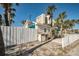 Rear view of beach cottage with white fence at 822 Gulf Blvd # 4-6, Indian Rocks Beach, FL 33785