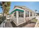 Another view of the yellow cottage with white fence and landscaping at 822 Gulf Blvd # 4-6, Indian Rocks Beach, FL 33785