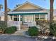 Charming yellow cottage with white picket fence and green awning at 822 Gulf Blvd # 4-6, Indian Rocks Beach, FL 33785