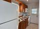 Small kitchen with wood cabinets and white appliances at 822 Gulf Blvd # 4-6, Indian Rocks Beach, FL 33785