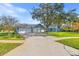 Two-car garage and attractive landscaping enhance this home's curb appeal at 8614 Maidstone Ct, Seminole, FL 33777