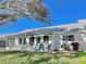 Back exterior of house with patio and lawn at 9336 Villa Entrada, New Port Richey, FL 34655