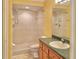 Bathroom with tiled walk-in shower and a wooden vanity with sink at 9336 Villa Entrada, New Port Richey, FL 34655