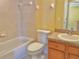 Bathroom with bathtub, toilet, and a vanity with sink and mirror at 9336 Villa Entrada, New Port Richey, FL 34655