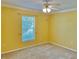 Bedroom with carpet floors, and a large window that lets in plenty of natural light at 9336 Villa Entrada, New Port Richey, FL 34655