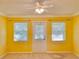 Bedroom with door and two windows, neutral walls at 9336 Villa Entrada, New Port Richey, FL 34655