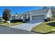 Front view of a single-story house with a garage and landscaped lawn at 9336 Villa Entrada, New Port Richey, FL 34655