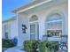 Inviting front porch with seating, beautiful landscaping, and decorative accents; perfect for relaxing at 9336 Villa Entrada, New Port Richey, FL 34655