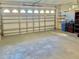 Spacious garage with overhead door, built in shelving, and ample storage space at 9336 Villa Entrada, New Port Richey, FL 34655