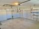 Spacious garage with storage shelving, and ample room for parking and projects at 9336 Villa Entrada, New Port Richey, FL 34655