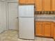 Kitchen features white appliances and wood cabinets at 9336 Villa Entrada, New Port Richey, FL 34655