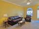 Living room features a brown leather sofa and chair set at 9336 Villa Entrada, New Port Richey, FL 34655