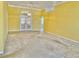 Spacious living room with high ceilings, carpet flooring, and decorative glass French doors at 9336 Villa Entrada, New Port Richey, FL 34655
