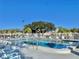 Community pool with surrounding lounge chairs at 9336 Villa Entrada, New Port Richey, FL 34655