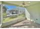Bright screened porch with tiled floor and ceiling fan at 9336 Villa Entrada, New Port Richey, FL 34655