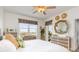 King bed, wicker furniture, and lovely water views from this bright bedroom at 13213 Gasparilla Rd # B305, Placida, FL 33946