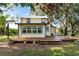 Back of charming yellow house with wooden deck at 1505 18Th W St, Bradenton, FL 34205