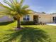 Single-story house with yellow exterior, palm tree, and landscaping at 18292 Hunters Meadow Walk, Land O Lakes, FL 34638