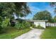 House exterior featuring a single-story home with a driveway and mature landscaping at 1901 N Highland Ave, Clearwater, FL 33755