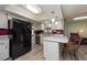 Modern kitchen with black refrigerator and granite countertops at 2203 Tail Feather Ct, Lutz, FL 33549