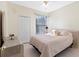 Cozy bedroom with tile floors, a window and neutral paint at 3203 Audubon Ct, Tarpon Springs, FL 34688