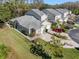 An aerial view showcasing the well-maintained exterior, landscaping, and multi-car driveway at 3203 Audubon Ct, Tarpon Springs, FL 34688