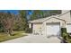 Charming single-Gathering home with a two-car garage, lush landscaping, and inviting curb appeal at 3203 Audubon Ct, Tarpon Springs, FL 34688