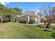 Well-maintained home with lush lawn, manicured hedges, and a side-entry two-car garage, creating curb appeal at 3203 Audubon Ct, Tarpon Springs, FL 34688