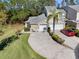 Charming home featuring a two-car garage and a well-manicured lawn with mature trees at 3203 Audubon Ct, Tarpon Springs, FL 34688