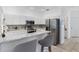 Modern kitchen featuring granite countertops, stainless steel appliances, white cabinetry, and bar stool seating at 3203 Audubon Ct, Tarpon Springs, FL 34688